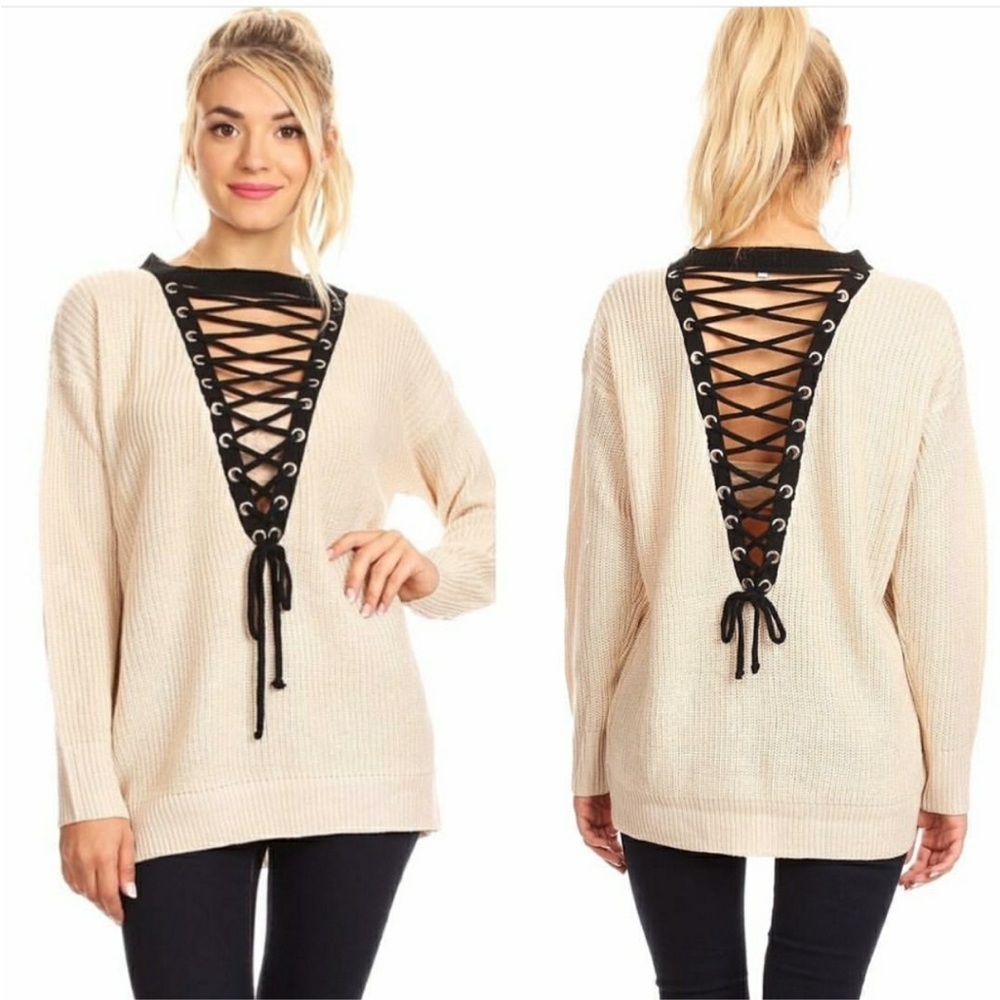 Size M/L cream sweater with front and back black V-neck lacing